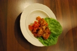 Schnitzel strips on a bed of lettuce 
and tomato salad.